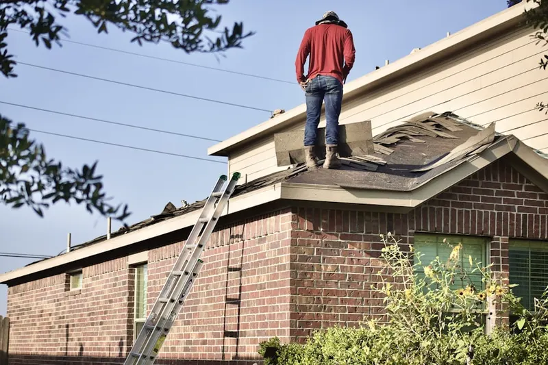Professional roofer working on a residential roof in Hinsdale